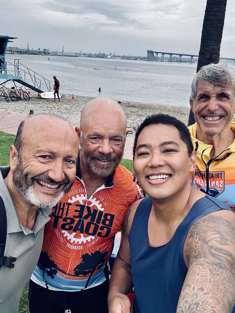 Josh in a selfie with three Triathlon Club of San Diego members by the bay