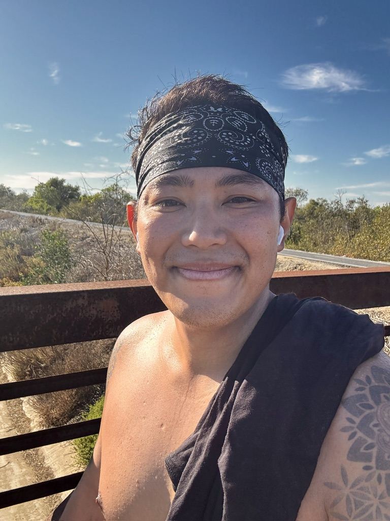 Josh smiling in a headband after a sunny solo run