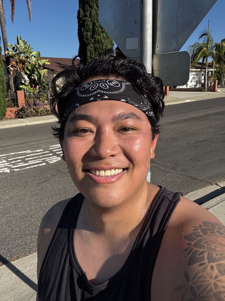 Josh smiling in a bandana headband after a solo run on a sunny Oceanside street