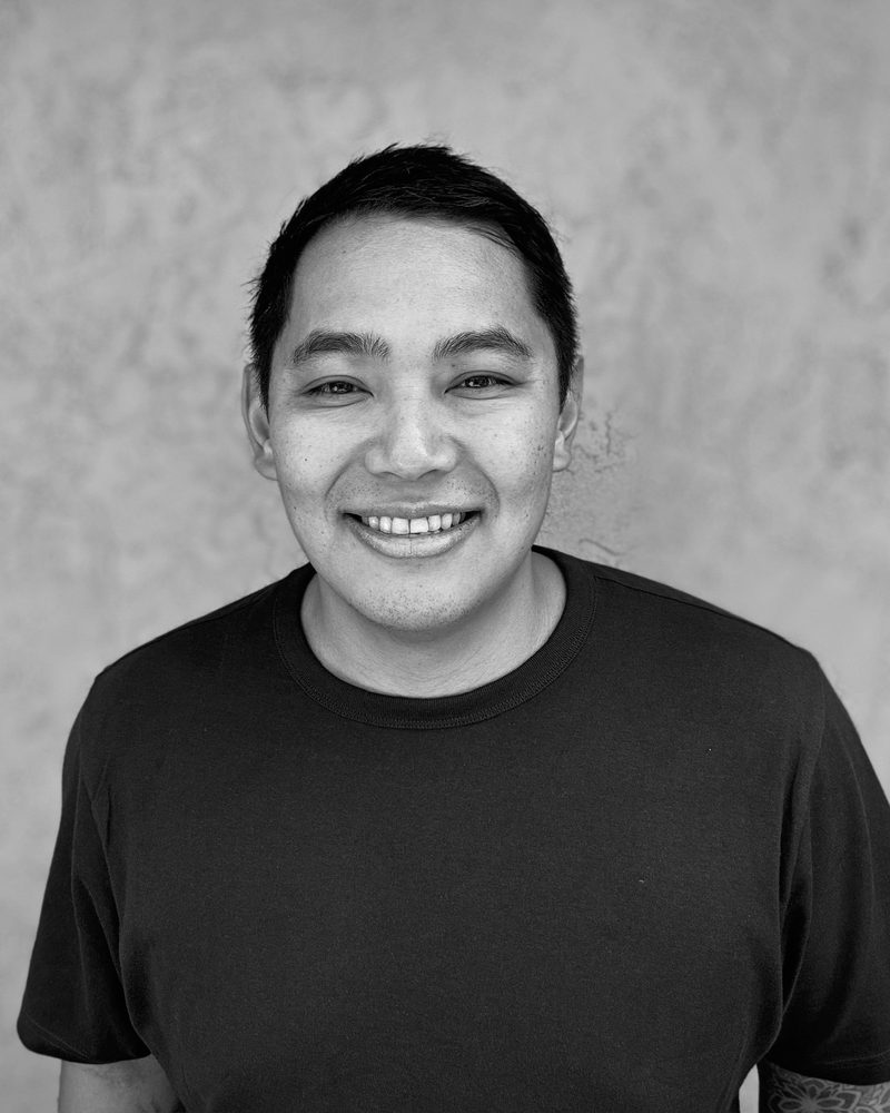 Joshua Moreno, smiling, in a black t-shirt